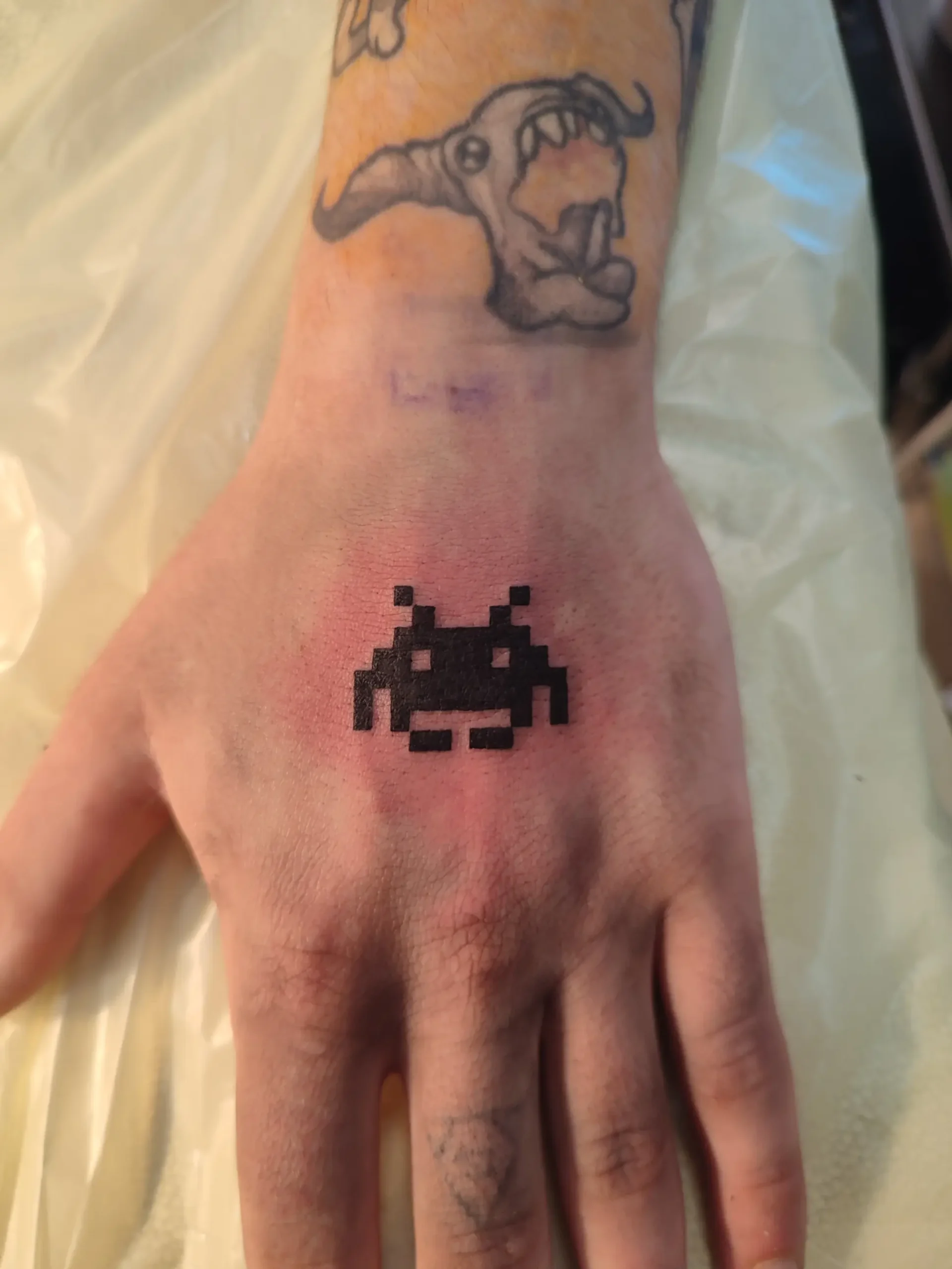 Fine line tattoo artwork done near the seaside